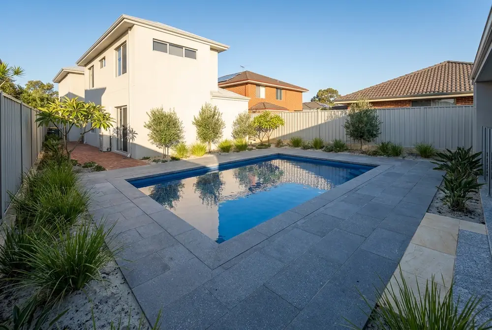 Blue grey bluestone pavers and capping around a backyard pool