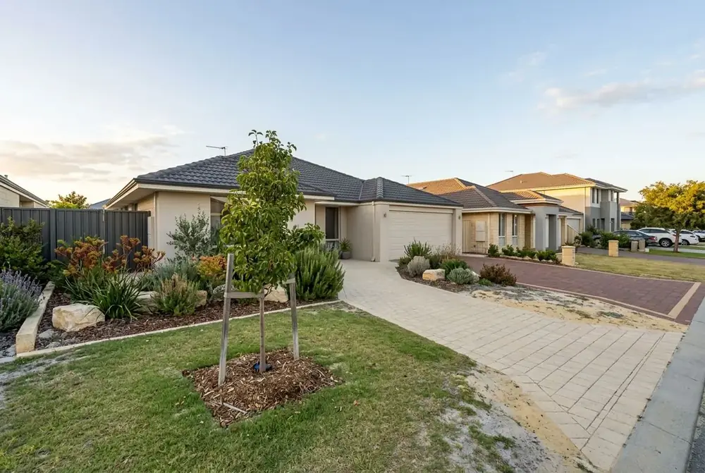 Narrow limestone coloured brick driveway at a 2010s home in Butler, Perth by IBP Paving