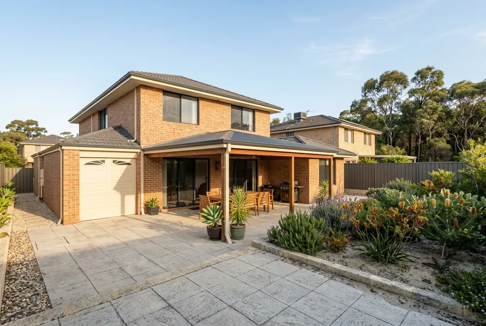 Paved alfresco on a 2000s Carramar home with native trees behind