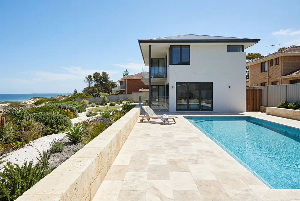 Travertine pool terrace at a rebuilt coastal home in City Beach, Perth