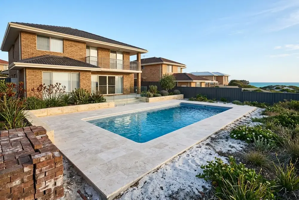 Travertine pool surround replacing salt damaged pavers at a 1980s home in Hillarys, Perth by IBP Paving