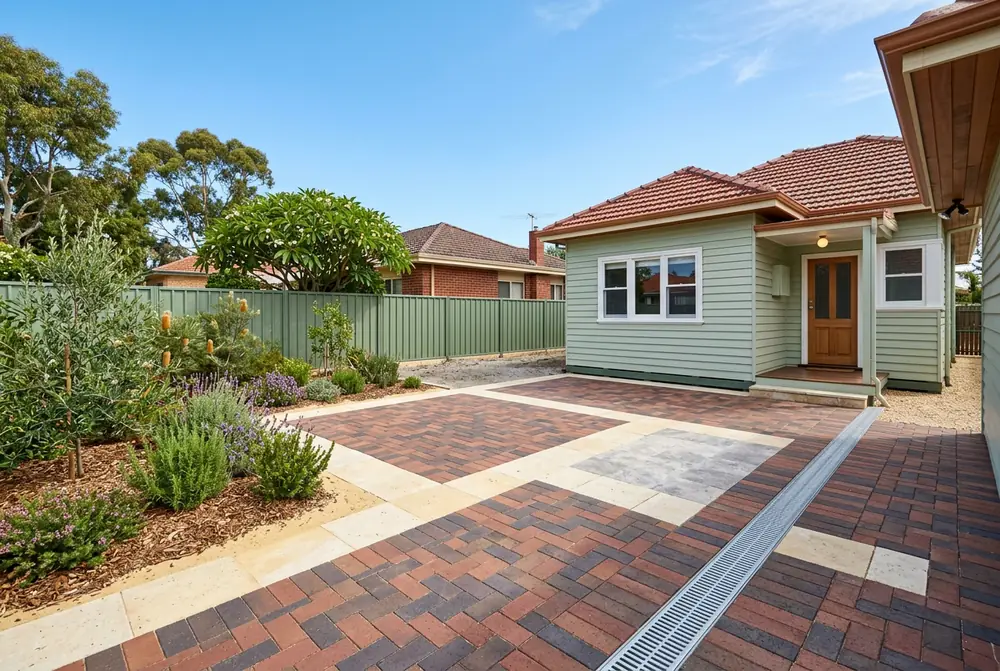 New courtyard paving with a strip drain at a post-war timber home in Innaloo, Perth