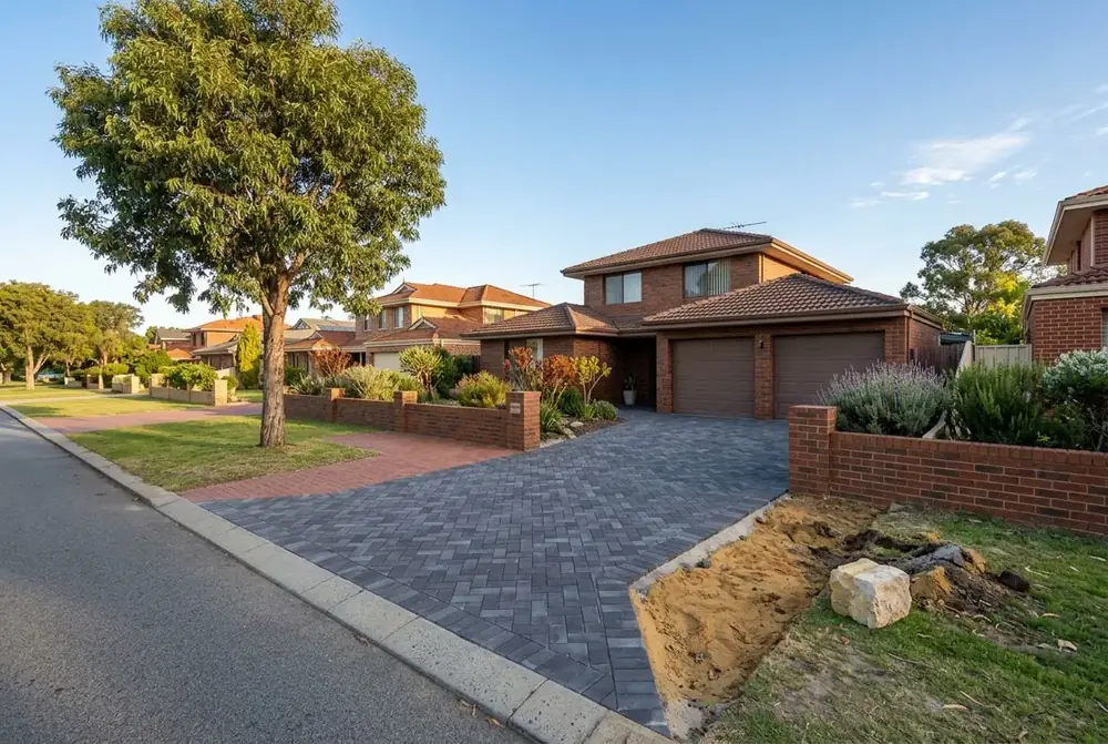 Relaid paver driveway set clear of a street tree at a late 1980s home in Joondalup, Perth by IBP Paving