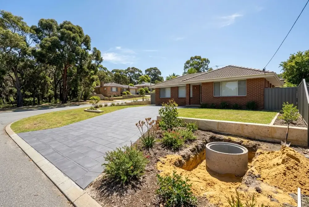 Large format concrete paved driveway and limestone wall at a 1960s home in Karrinyup, Perth by IBP Paving
