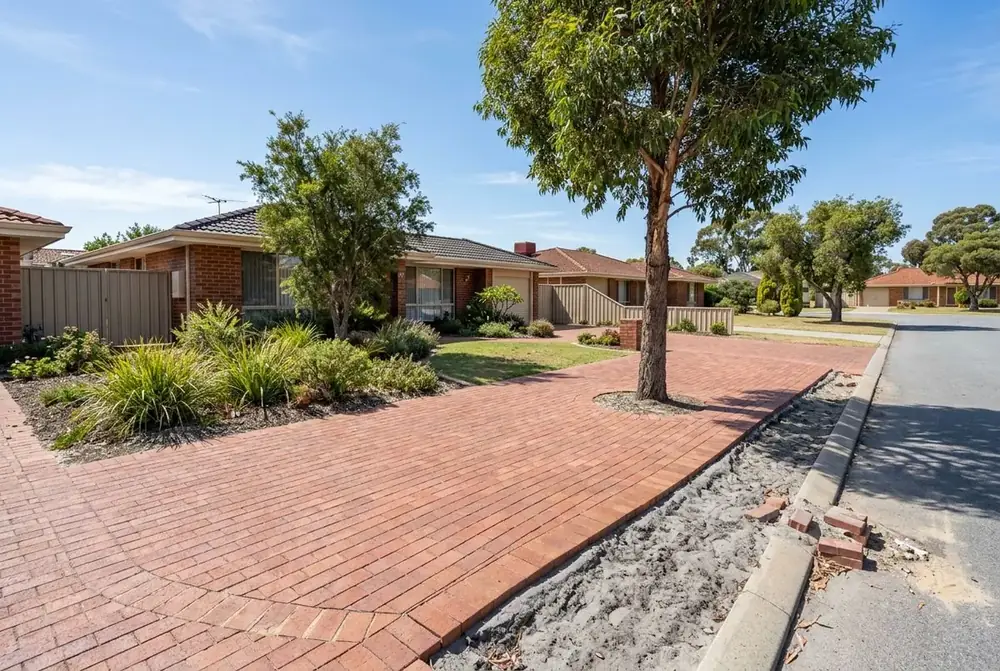 Brick paved verge around a street tree outside a 1980s home in Marangaroo, Perth by IBP Paving
