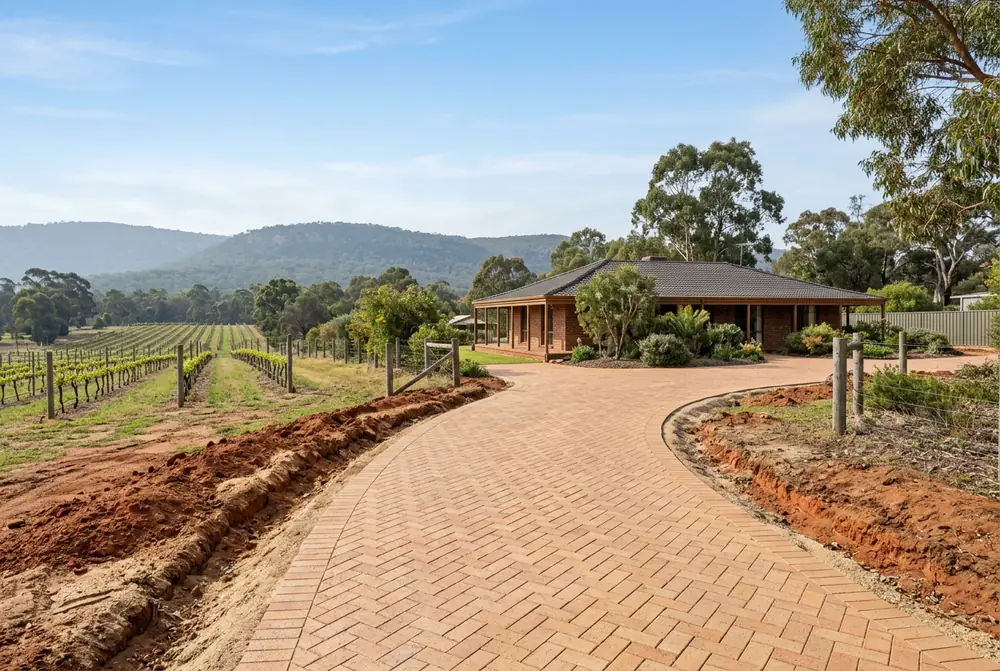 Clay brick driveway replacing gravel at a 1970s acreage home on red brown clay in Upper Swan