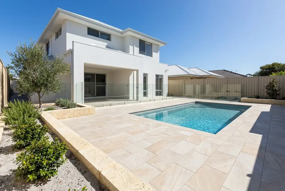 Beige stone look porcelain pavers around a Perth pool