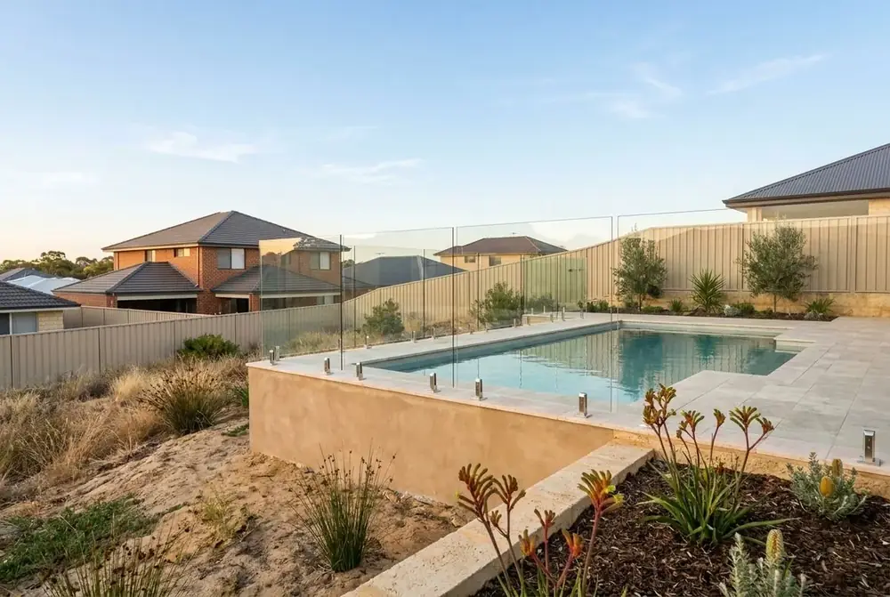 Limestone retaining wall and travertine pool surround in Perth