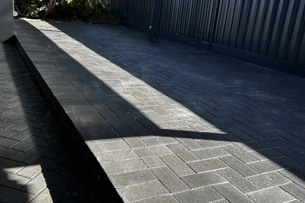 Charcoal paving under a patio in Perth by IBP Paving