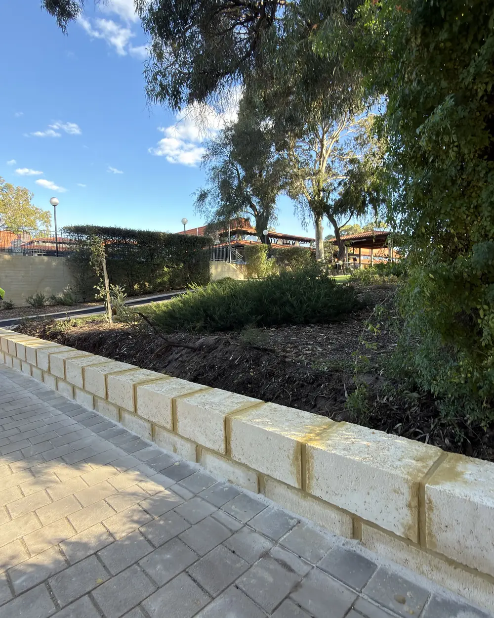Limestone retaining wall, garden bed and paved path in Perth by IBP Paving