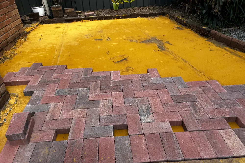Brick pavers being laid on screeded bedding sand in Perth by IBP Paving